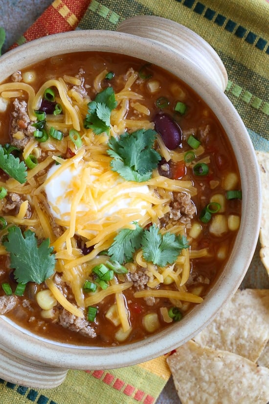 This quick turkey chili taco soup satisfies my soup cravings, takes just 20 minutes to cook but it tastes like it was simmering for hours! Top it with your favorite chili toppings such as sour cream, cheese or whatever you like for a healthy meal that can be prepped for the week or frozen for another night.
