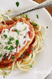 Baked Chicken Parmesan is a lightened up version of an Italian classic! Baking the cutlets instead of frying lightens this dish up while remaining moist and full of flavor, plus it's so much cleaner and easier. Serve this over pasta or with a large salad to keep it on the lighter side.