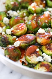 These Brussels sprouts start out in the skillet and get finished in the oven for perfectly charred edges, then they are drizzled with hot sauce and crumbled blue cheese – SO good!!
