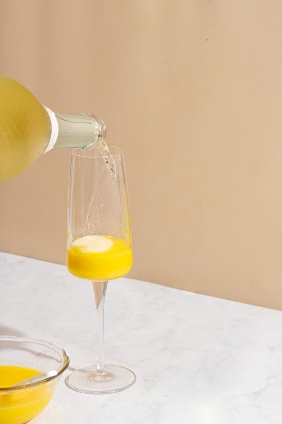 pouring prosecco into glass