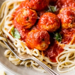 Italian Turkey Meatballs with spaghetti on a plate.