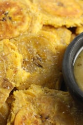 These Baked Tostones or twice "Fried" Plantains aren't fried at all, they are baked in the oven which makes them a delicious, healthy side dish or appetizer!
