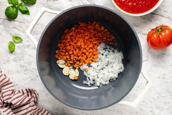 This filetto di pomodoro tastes far better than store-bought pasta sauces! You only need a few ingredients for this authentic Italian recipe. Carrots, onion, and garlic in pot.