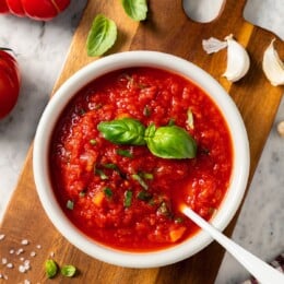 Bowl of filetto di pomodoro sauce with spoon.