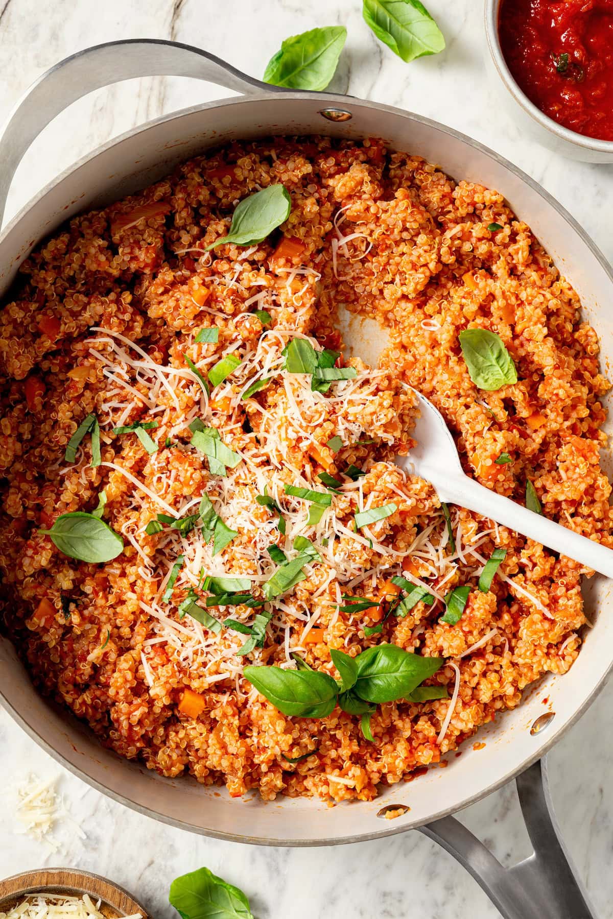 Skillet of quinoa risotto with serving spoon.