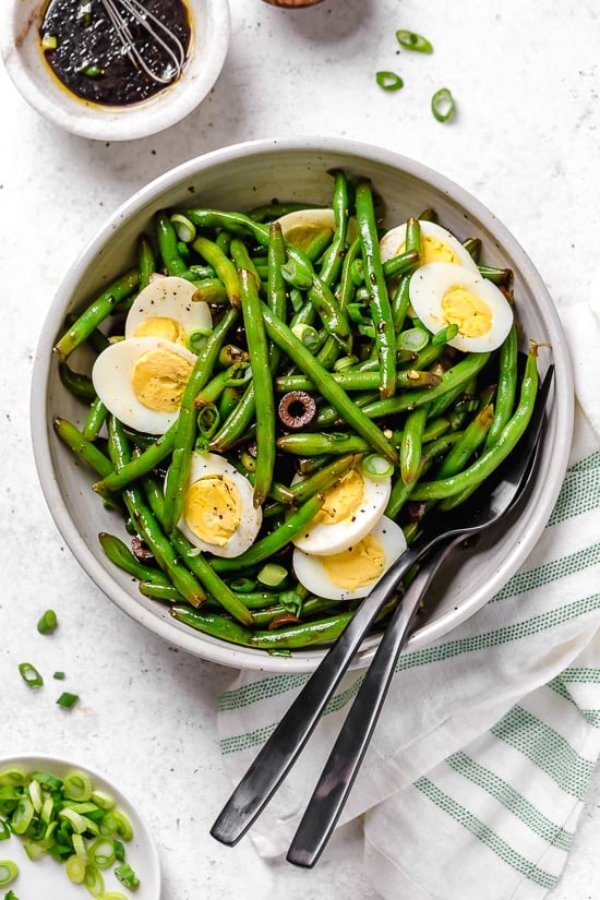 One of my favorite ways to enjoy green beans–in a chilled green bean salad recipe! The delicious flavors of these balsamic green beans made with black olives, scallions and eggs complement any meal or holiday potluck.