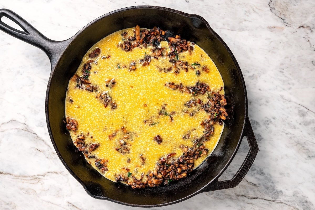 Mushroom frittata ingredients combined in a cast-iron skillet.