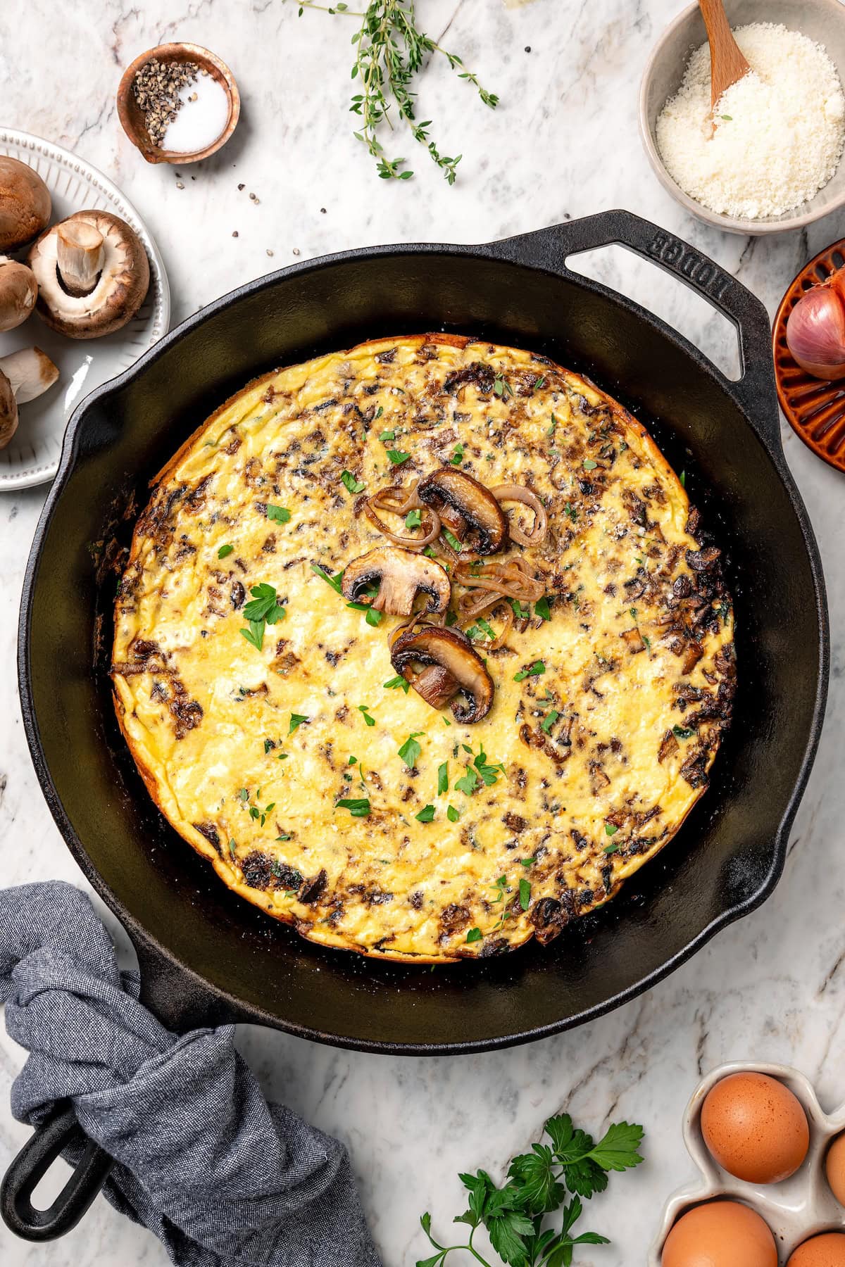 Overhead view of a mushroom frittata in a skillet.