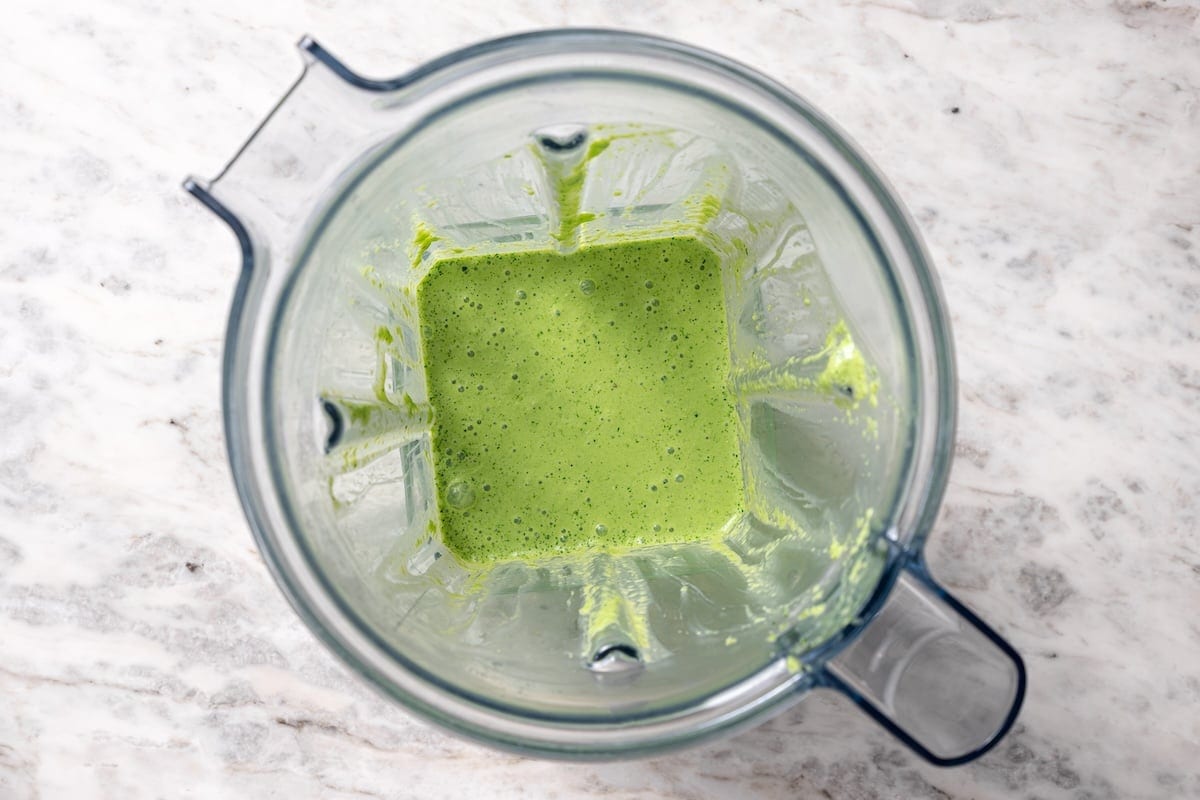 This juicy, restaurant-style Peruvian chicken is marinated overnight and oven-roasted for golden, crispy skin. Served with spicy green sauce. Blended Peruvian green sauce inside the blender.