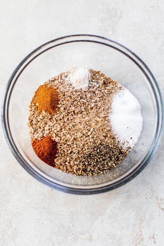 Ingredients for bran flake chicken coating in glass bowl before stirring.