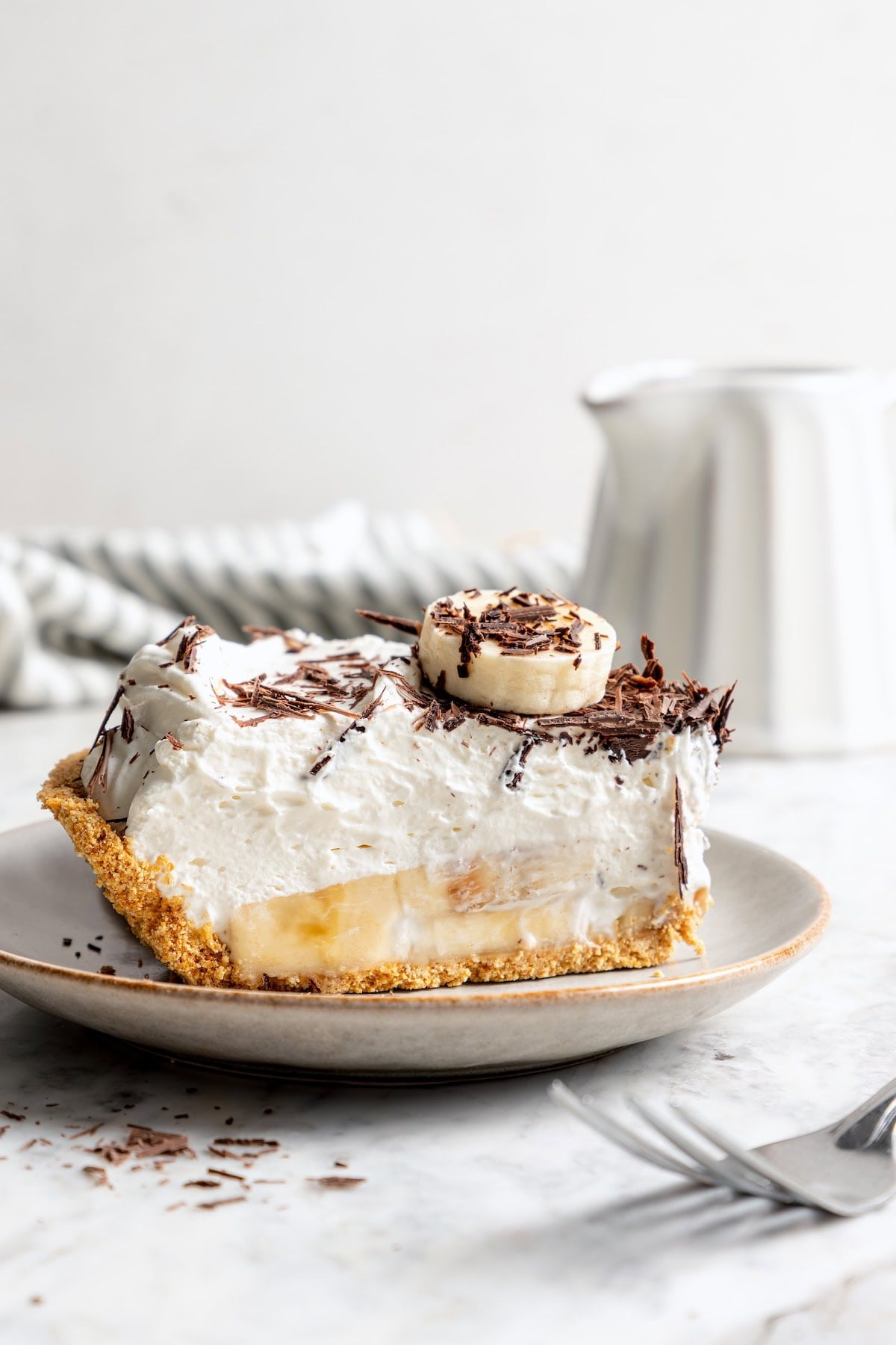 Slice of no bake banana cream pie on plate.