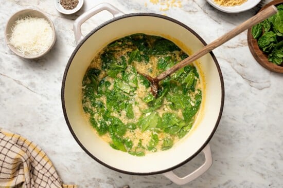 Pot of stracciatella soup with spinach.