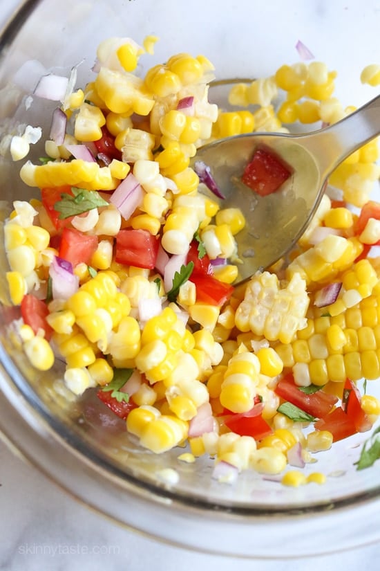This easy corn salsa made with lime, cilantro and tomatoes are perfect with chips or served over your favorite tacos or burrito bowls!