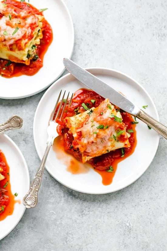 These EASY Spinach Lasagna Roll ups are totally delicious, perfect for entertaining or serving for weeknight meals. Individual vegetarian lasagnas filled with spinach and cheese are family-friendly, satisfying and perfect for portion control. It's also a great way to get your kids to eat spinach and no one will miss the meat!