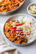 Turkey Picadillo with rice and slaw on a plate.
