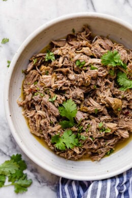 Slow Cooker Pork Carnitas or Mexican Pulled Pork is the best Mexican pork recipe whether you stuff it into a tortilla, taco or turn it into a burrito bowl!