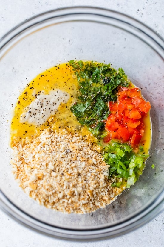 This easy baked crab cakes recipe combines juicy lump crab meat, simple seasonings, and fresh herbs. Perfect as an appetizer or light dinner! Crab cake seasonings combined in a bowl.