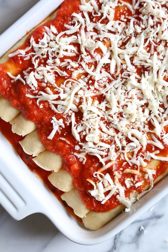 The secret to the best, irresistible manicotti is to make them from scratch with my easy homemade crespelles, which are basically Italian crepes. These spinach and cheese manicotti are filled with three cheeses – ricotta, mozzarella and parmesan, then topped with homemade sauce. So damn delicious!