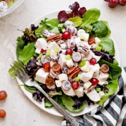 Plate of chicken Waldorf salad with fresh greens.