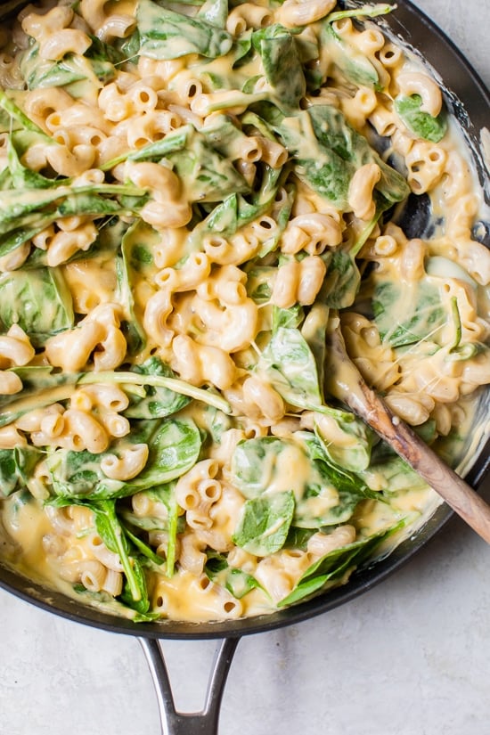 This creamy baked mac and cheese recipe is a lighter version of the classic recipe with added fiber from spinach. It's comfort food at it's finest!
