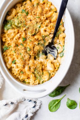 This creamy baked macaroni and cheese recipe is a lighter version of the classic recipe with added fiber from spinach. It's comfort food at it's finest!