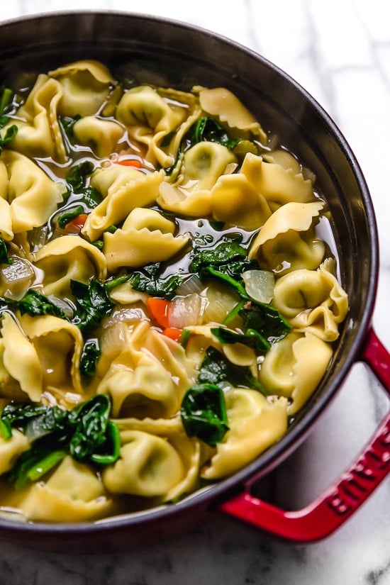 Spinach Tortellini en Brodo (in broth) is an Italian soup made with spinach and cheese tortellini and vegetables in a light broth.