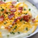 This slimmed down version of a loaded baked potato soup has everything you love about a baked potato – sour cream, cheddar, bacon and chives, at a fraction of the calories!