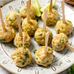 Baked southwest turkey meatballs with picks on plate.
