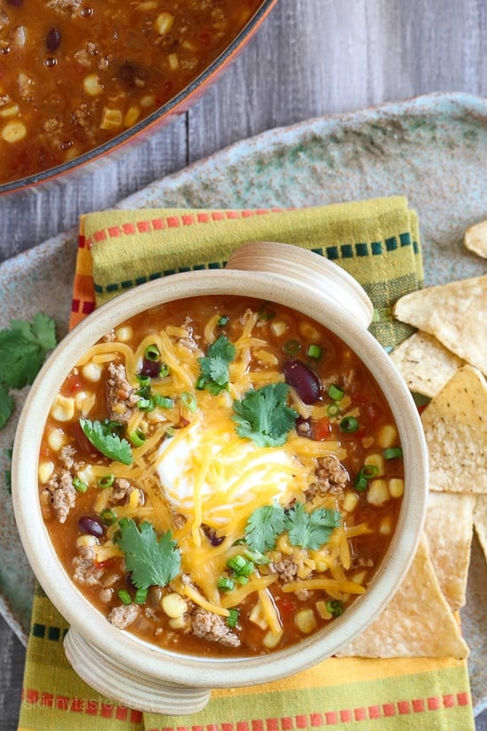 This quick turkey chili taco soup satisfies my soup cravings, takes just 20 minutes to cook but it tastes like it was simmering for hours! Top it with your favorite chili toppings such as sour cream, cheese or whatever you like for a healthy meal that can be prepped for the week or frozen for another night.