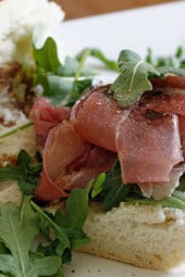 This prosciutto di Parma, peppery arugula, sweet balsamic and heart healthy olive oil on french bread is a winning combination.