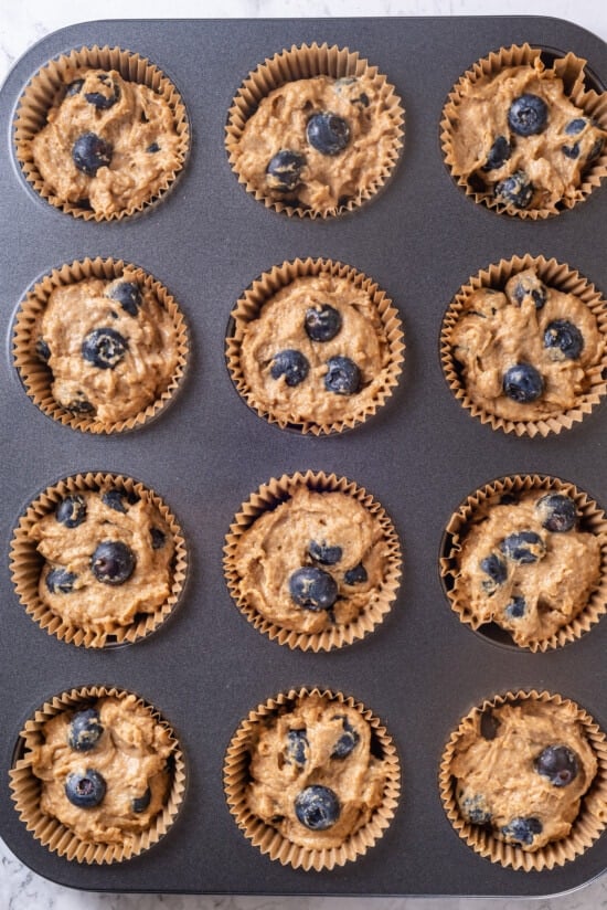 Overhead view of blueberry muffin batter in pan