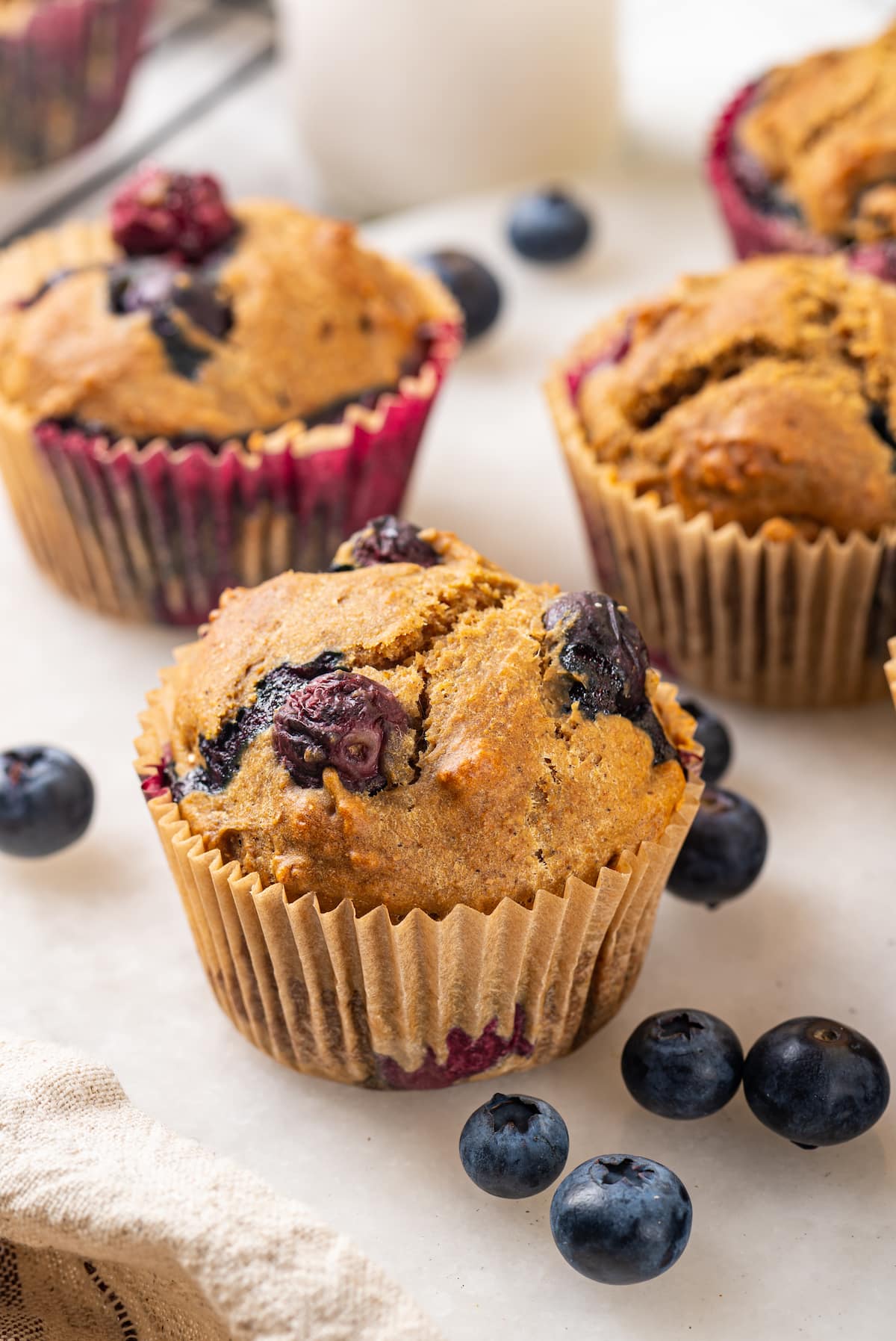 Blueberry muffin made with whole wheat pastry flour, with additional muffins in background