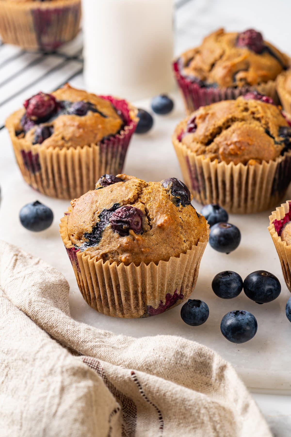 Blueberry muffins on marble board with fresh berries