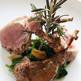 Lamb chops marinated with a glaze of Dijon mustard, garlic, balsamic vinegar and herbs served over a bed of wilted baby spinach in garlic and oil. This is so good you'll be licking the bones clean!