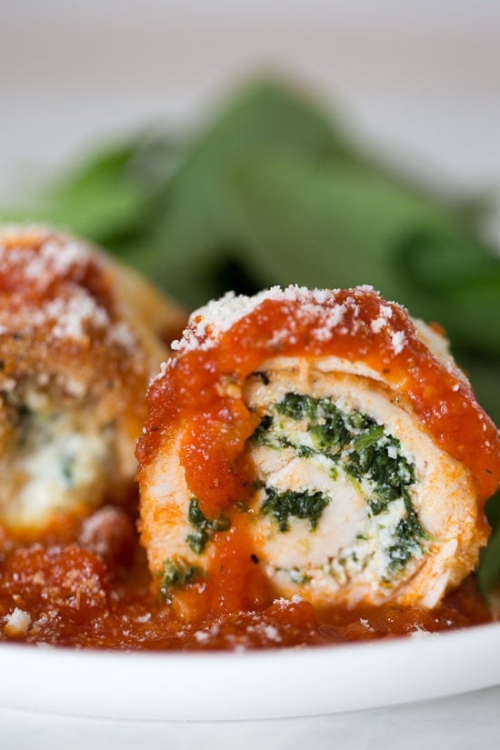 Chicken Rollatini with Spinach alla Parmigiana is Italian comfort food at it's finest! Made with breaded chicken breasts filled and rolled with spinach and cheese topped with sauce and melted mozzarella.