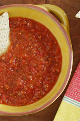 This spicy red salsa is made with fresh tomatoes, roasted jalapeño, garlic and cilantro, pureed in a blender then simmered until the tomatoes deepen in color. Serve with your favorite baked chips and Sinless Margaritas!