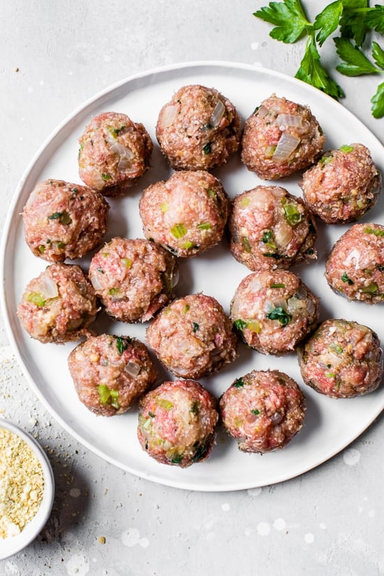 Meatballs on a plate before cooking.