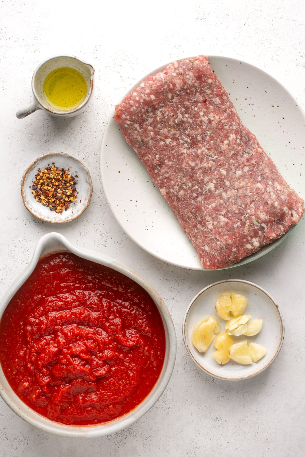 Ingredients needed for Italian sausage pasta sauce.