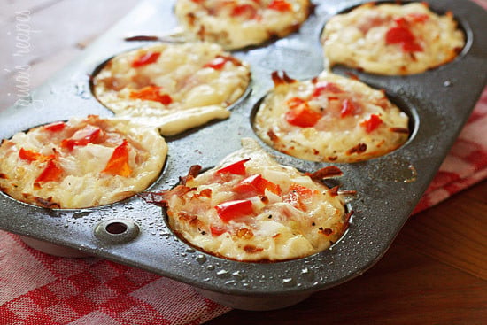 Cooked Hash brown egg white nests in a muffin tray.