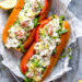 Lobster Rolls scream summer to me! Made with chunks of chilled lobster tossed with celery, shallots, chives, light mayonnaise and a little lemon zest served on a hot dog bun – delicious!