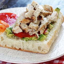 An open faced sandwich on Ciabatta bread with mashed avocado, sliced tomatoes and grilled chicken. A perfect way to use up leftover chicken.