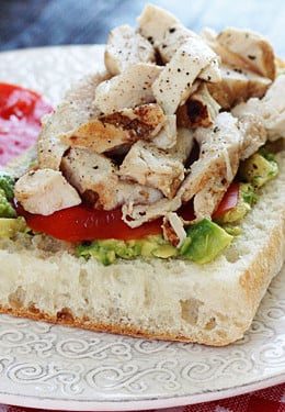 An open faced sandwich on Ciabatta bread with mashed avocado, sliced tomatoes and grilled chicken. A perfect way to use up leftover chicken.