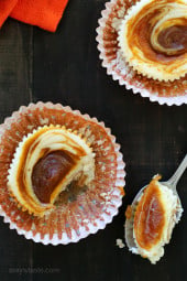 These cheesecake cups are made light with Greek yogurt and swirled with pumpkin butter on top. Vanilla wafers on the bottom of these cheesecake cups create a simple, no-fuss crust. When the cheesecake cups bake, the cookies soften and all the flavors work together.