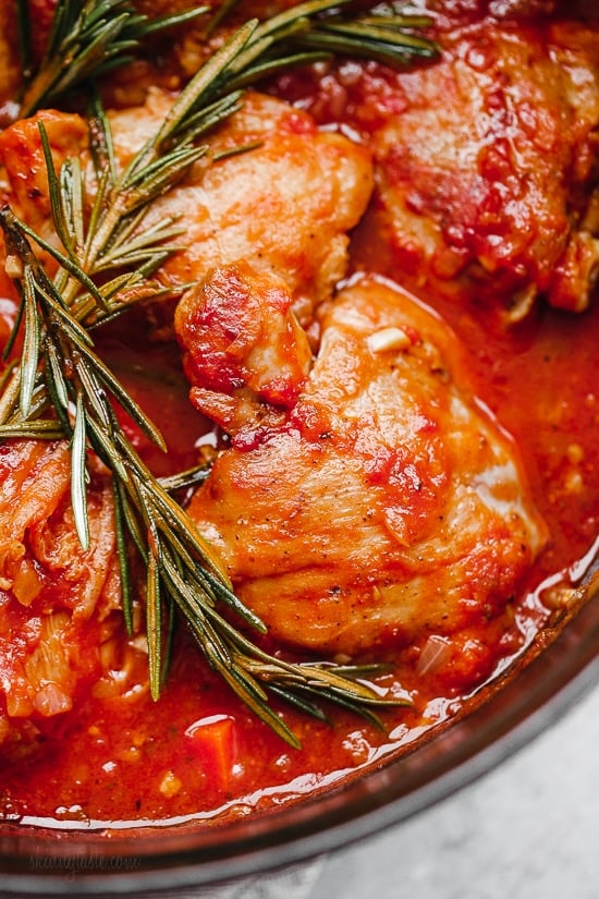 Pollo in Potacchio is an Italian braised chicken dish made with tomatoes, rosemary and garlic. The chicken cooks until it's fork tender, which is great served with pasta, noodles or polenta.