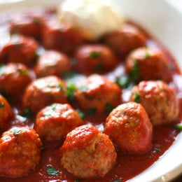 Slow cooker Italian turkey meatballs with tomato sauce in a large serving dish.
