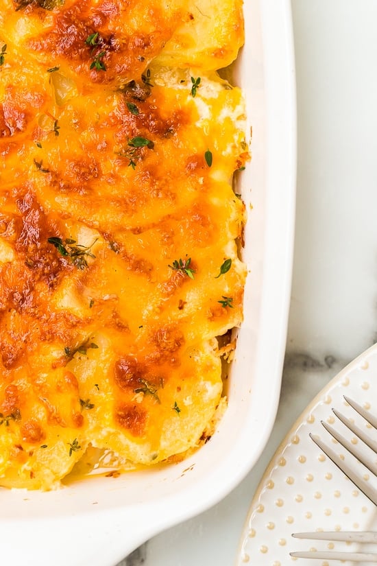 This Scalloped Potato Gratin recipe made with thinly sliced Yukon gold potatoes layered with cheese and a light buttery sauce is my favorite holiday side dish!