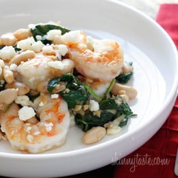 Shrimp, white beans and wilted spinach topped with crumbled feta. Perfect for a weeknight meal, this dish is delicious and super easy to make!