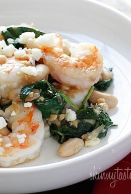 Shrimp, white beans and wilted spinach topped with crumbled feta. Perfect for a weeknight meal, this dish is delicious and super easy to make!