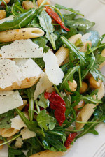 Peppery arugula tossed with nutty chick peas, penne pasta, sun dried tomatoes, shaved parmesan and balsamic vinegar make a simple yet delicious main dish salad – perfect for lunch or dinner. Portions are large, loaded with fiber and very satisfying.