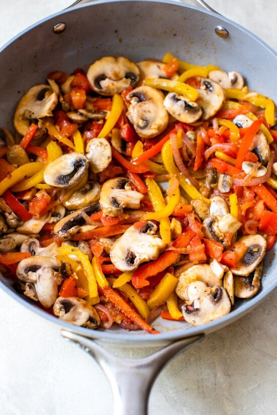 bell peppers and mushrooms in a skillet